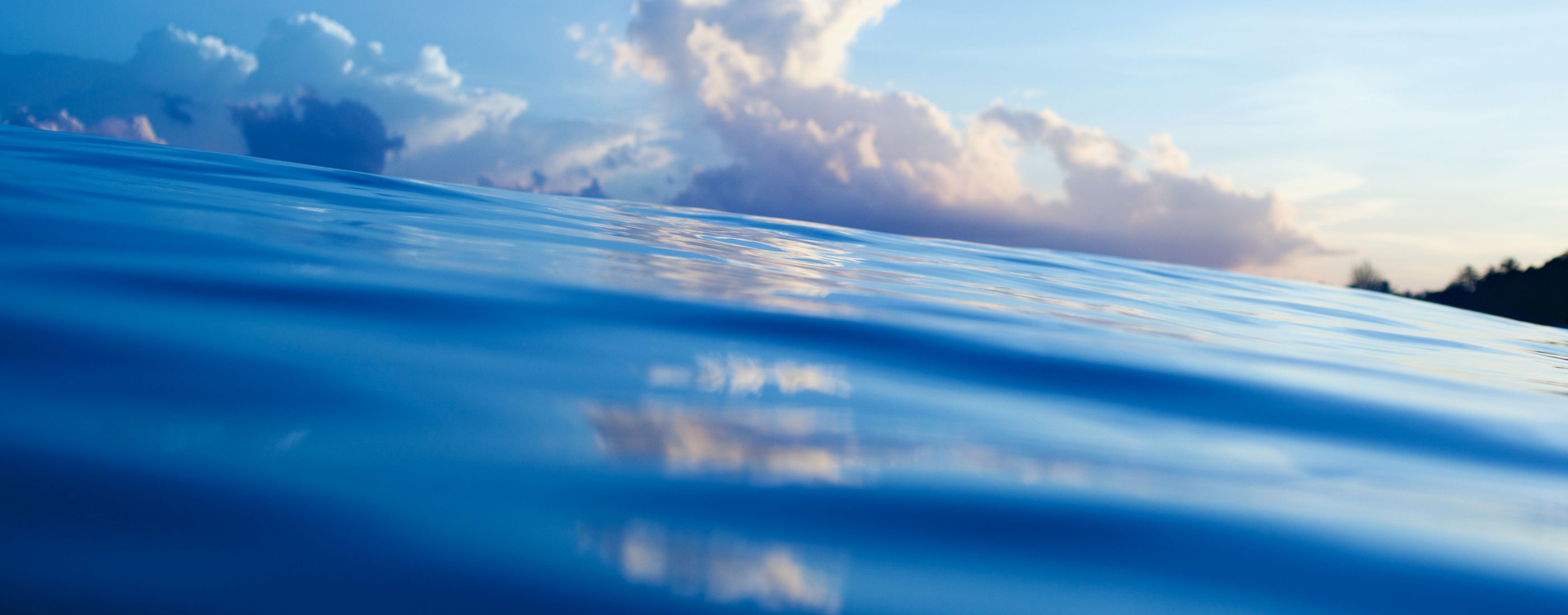 Clouds are seen in the horizon just above the ocean's surface