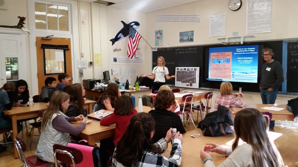 Students in a classroom listening to a presentation